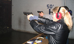 Heather Bosch fires a gun for the first time as part of her series Taking Up Arms
