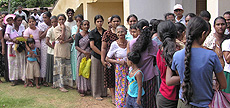 Victims of the tsunami wait for food rations