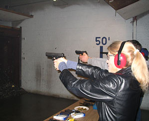 Heather Bosch aims a gun at a target while getting NRA certification for her news series Taking Up Arms