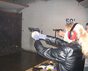 Heather Bosch pulls the trigger on a hand gun during NRA certification training for her news series Taking Up Arms