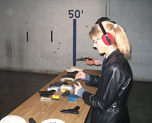 Heather Bosch seen loading a pistol with ammunition for her news series Taking Up Arms