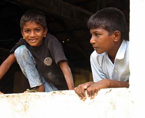 Children waiting for their parents who are gettting supplies from World Vision after the tsunami in 2004. Sri Lanka.