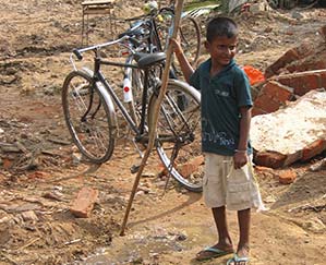 A young boyholds a walking stick following the 2004 tsunami.