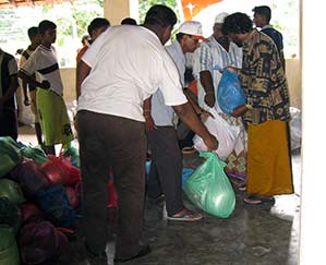 Bags of supplies are given to survivors of the 2004 tsunami in Sri Lanka